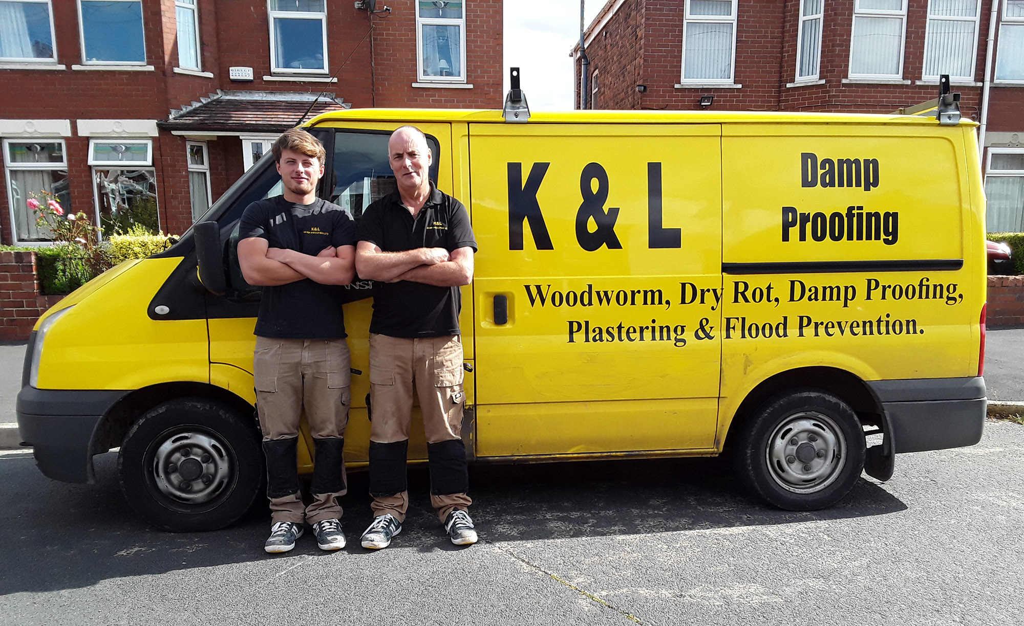 Workers standing next to K&L van